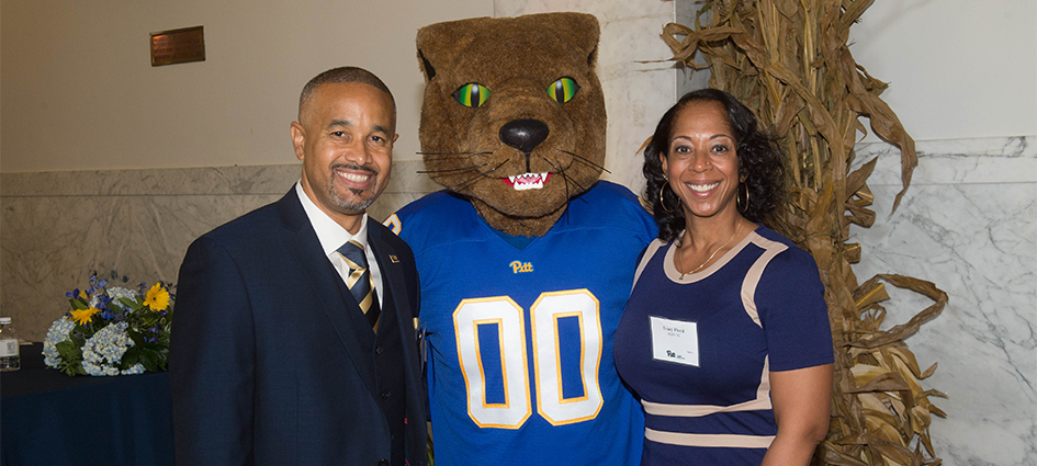 Darryl (A&S ’89, MED ’94) and Tracy (NURS ’91) Floyd pose with Roc at the 2017 Alumni Awards Luncheon after being honored with the Roc Spirit Award.